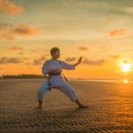 boy doing karate routines during golden hour